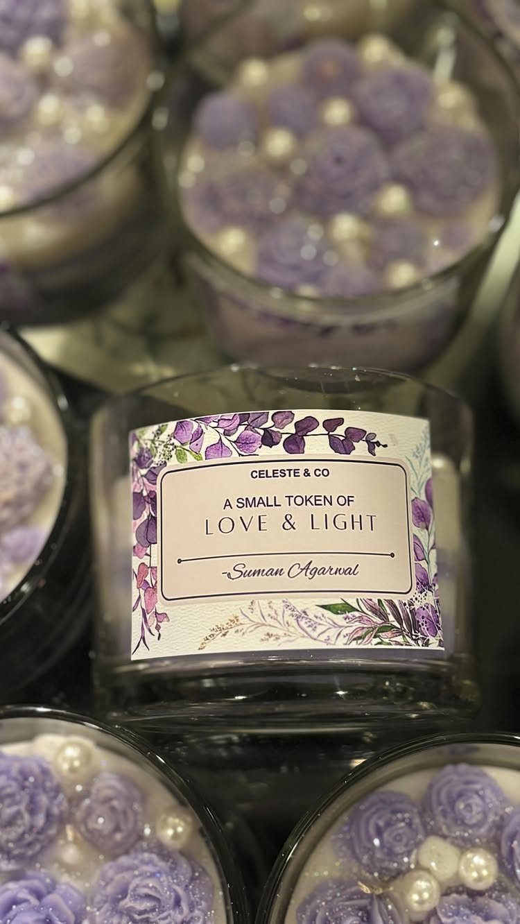 Glass jars with purple wax roses and pearls, featuring a personalized gift label.